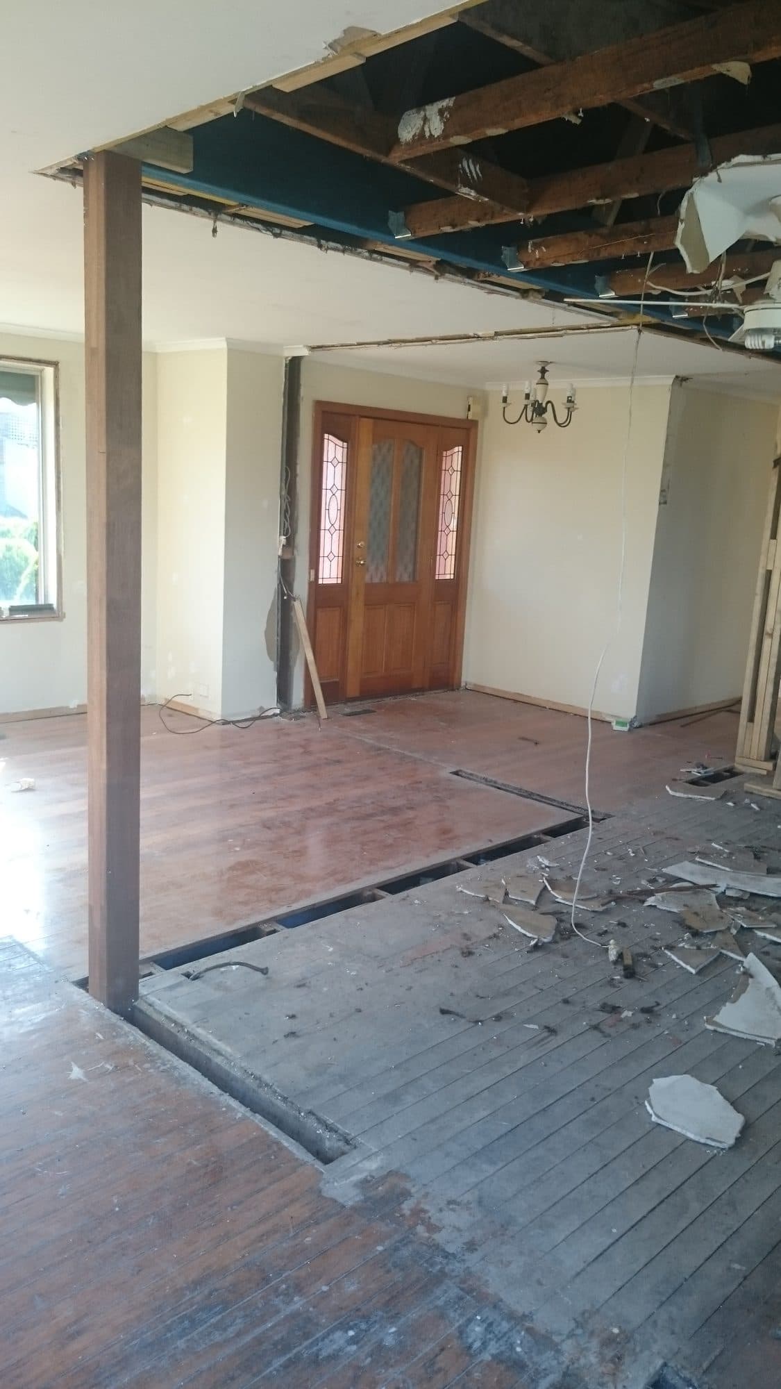 The wall removed, looking towards the front door past the new post