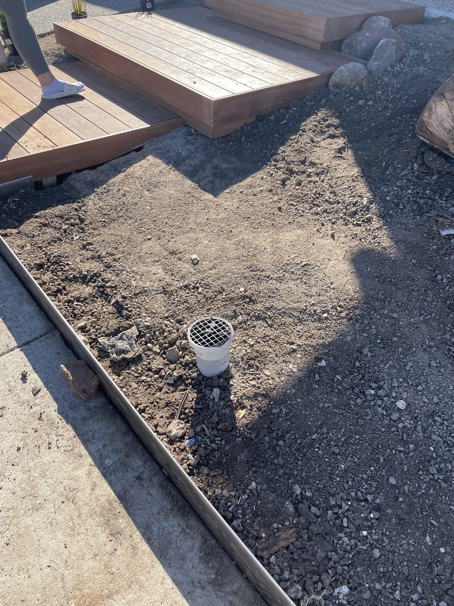 A garden bed edged in steel beside the steps