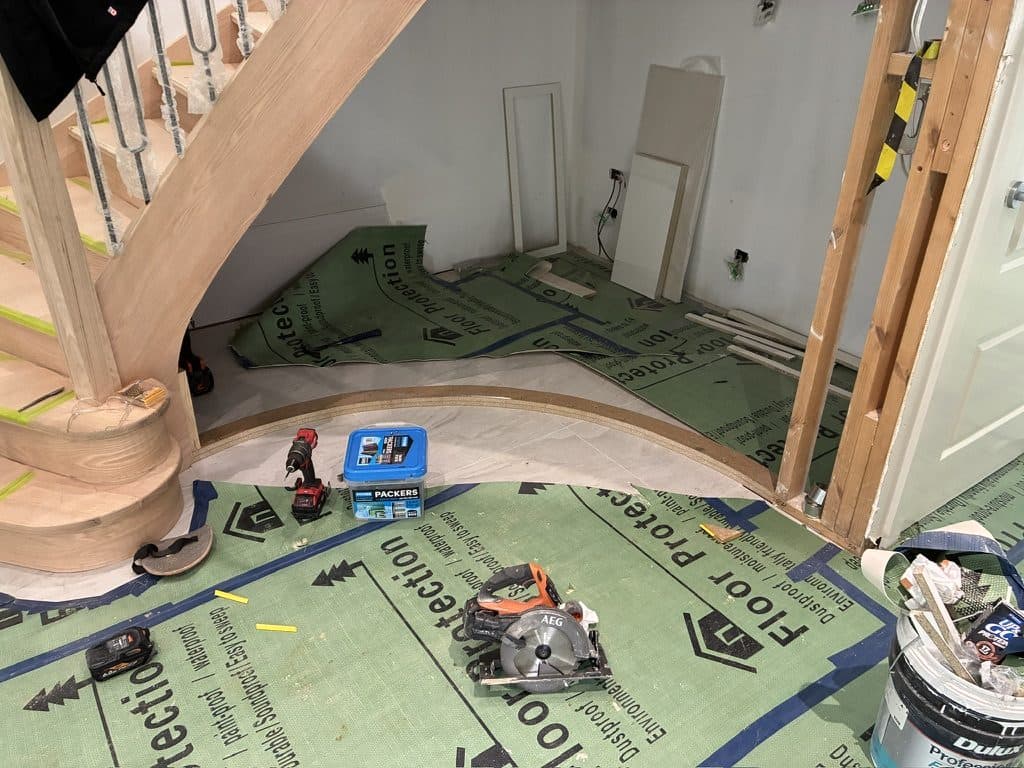The base of a curved timber staircase with a curved bottom step