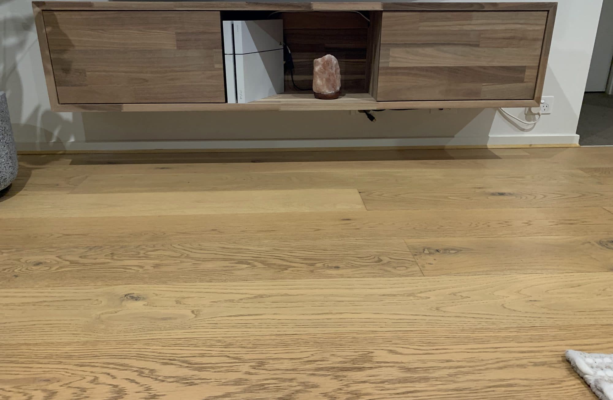 A floating timber entertainment unit installed above an oak floor