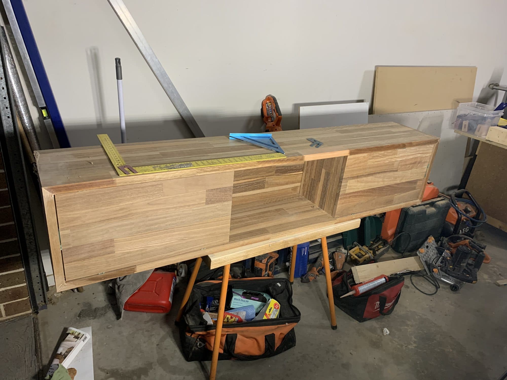 A timber entertainment unit being built on trestles in a workshop