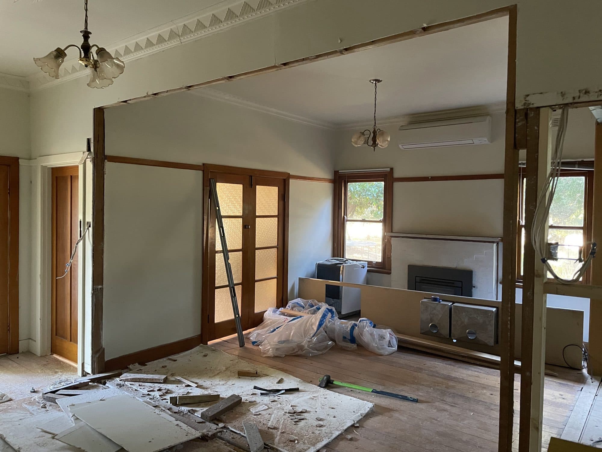 A wall removed between two rooms, with a new header in place