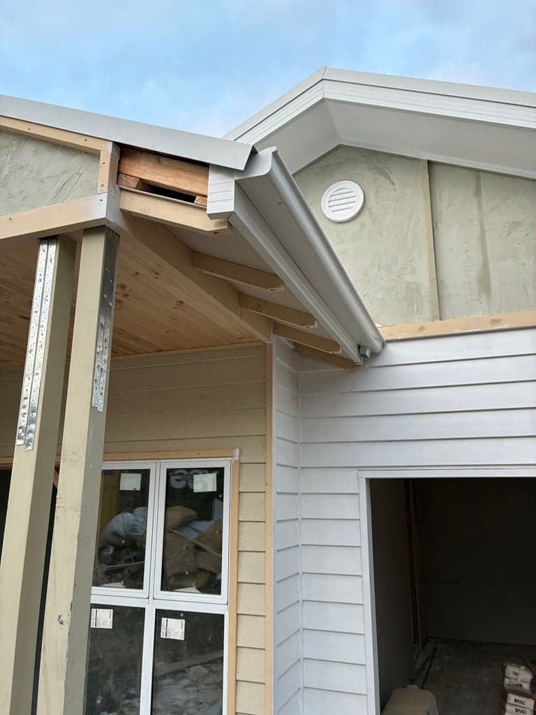 New weatherboard gables and eaves on a house extension under construction