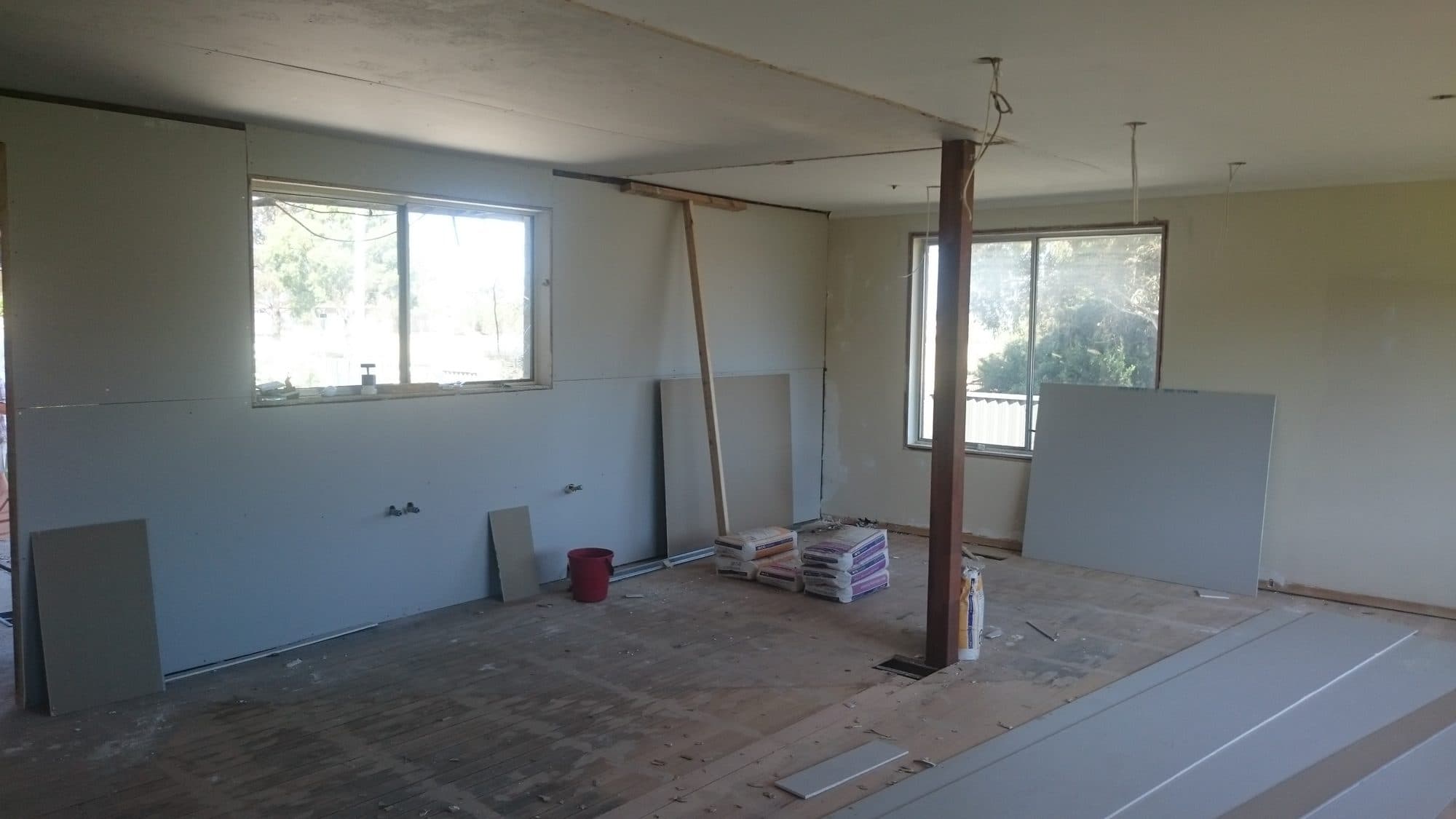A room lined with new plasterboard ready for setting