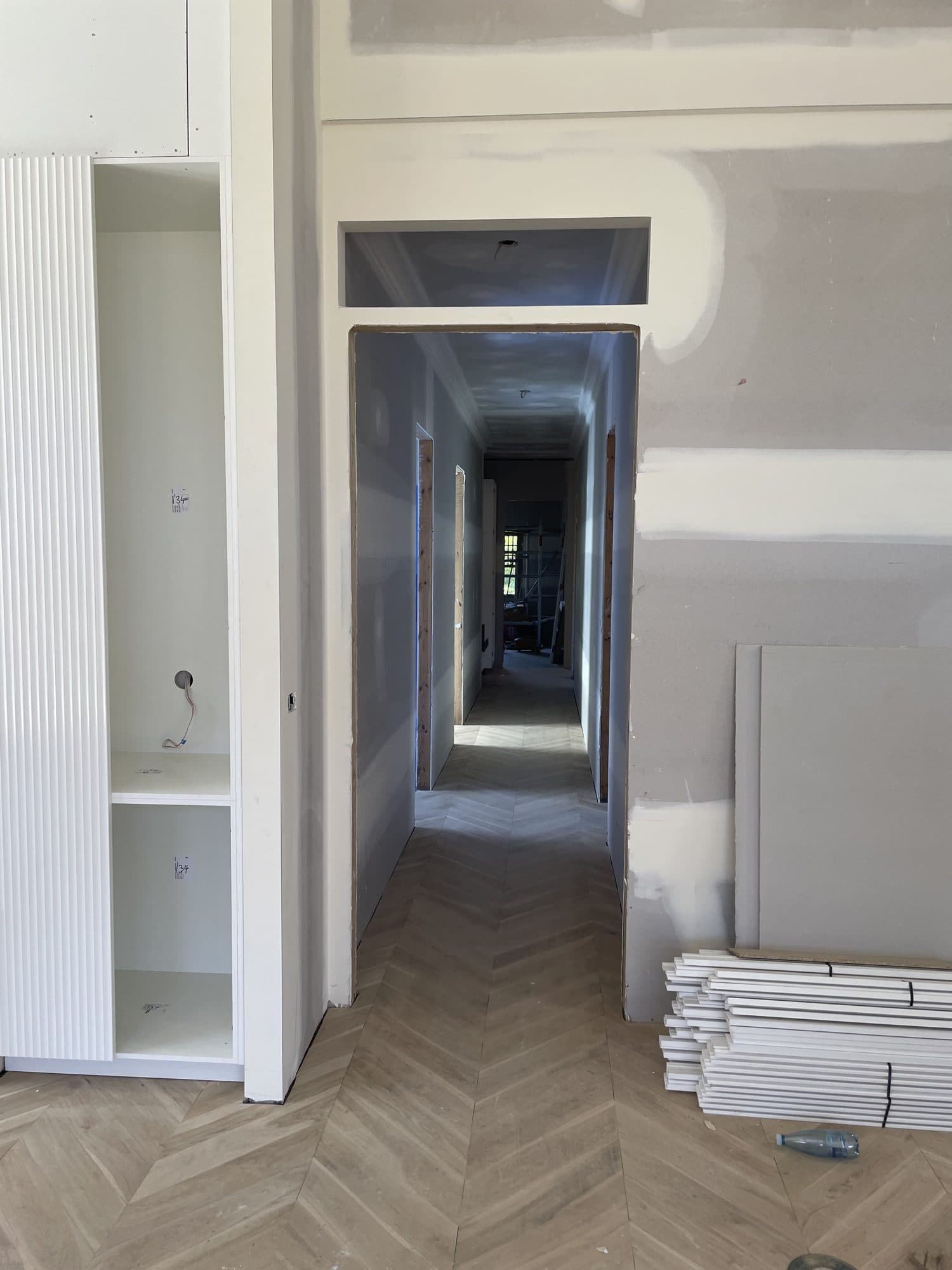 Set plaster in a hallway, with built-in joinery on the left