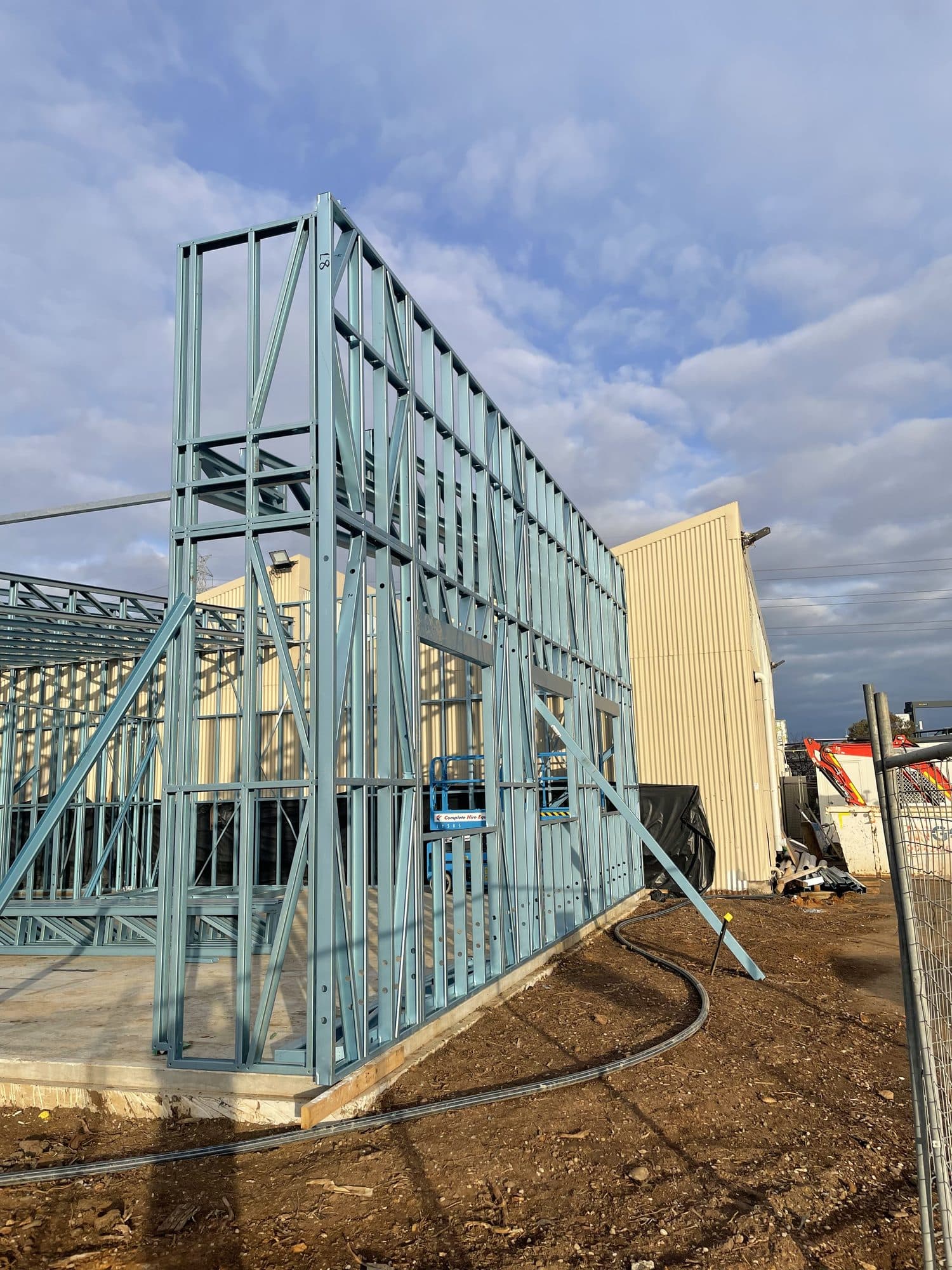 A tall steel frame beside the building