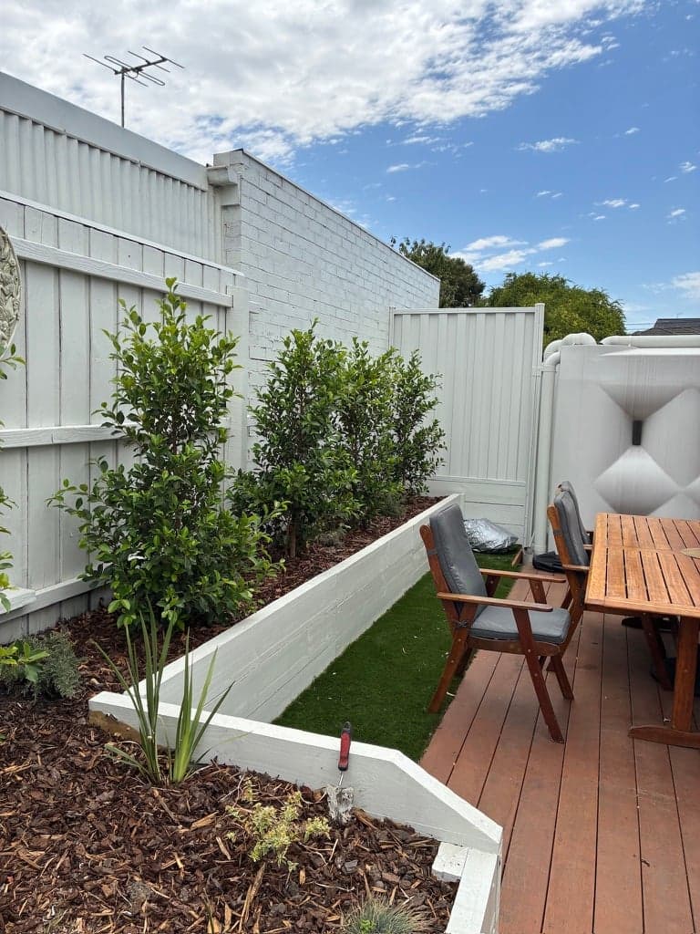 The deck and raised planter bed with no roof over them