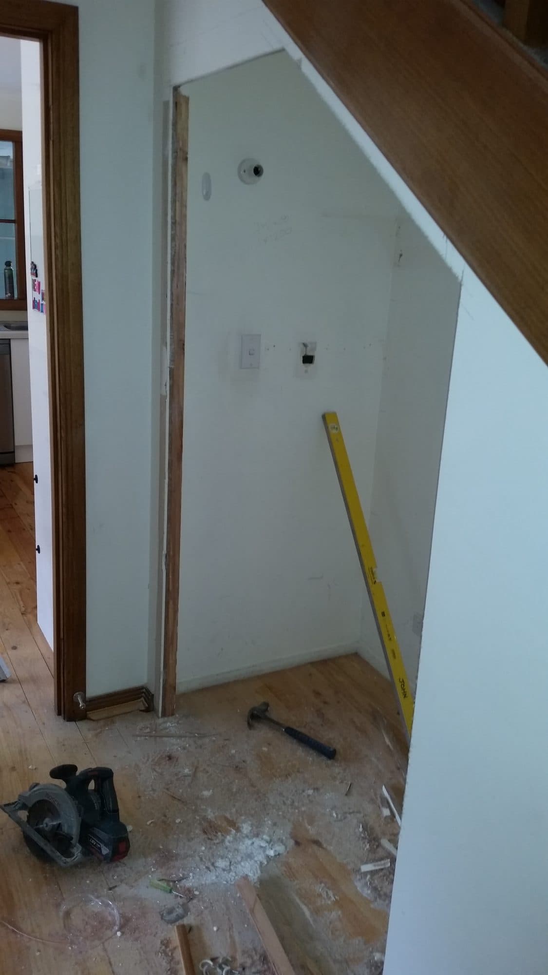 The under-stair space from the side, with tools on the floor