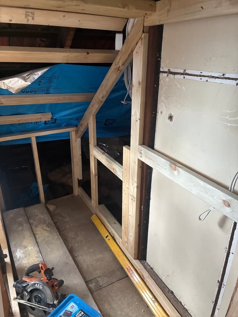 The frame of the new room, with the old roof structure behind it