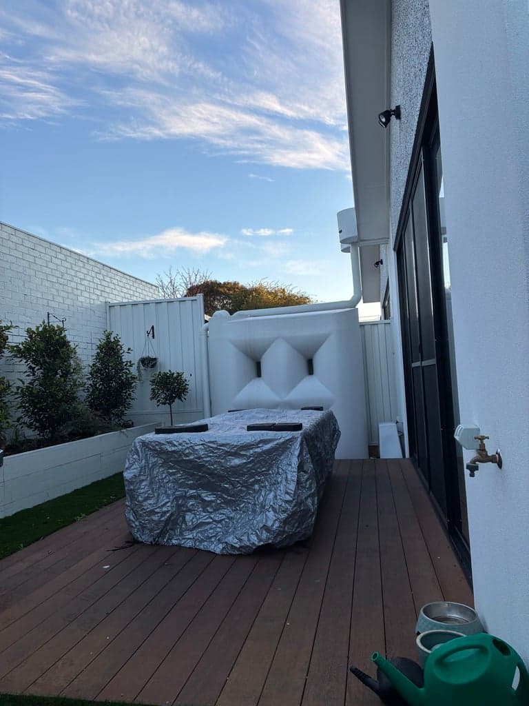 The deck before the pergola, open to the sky, looking toward the rain tank