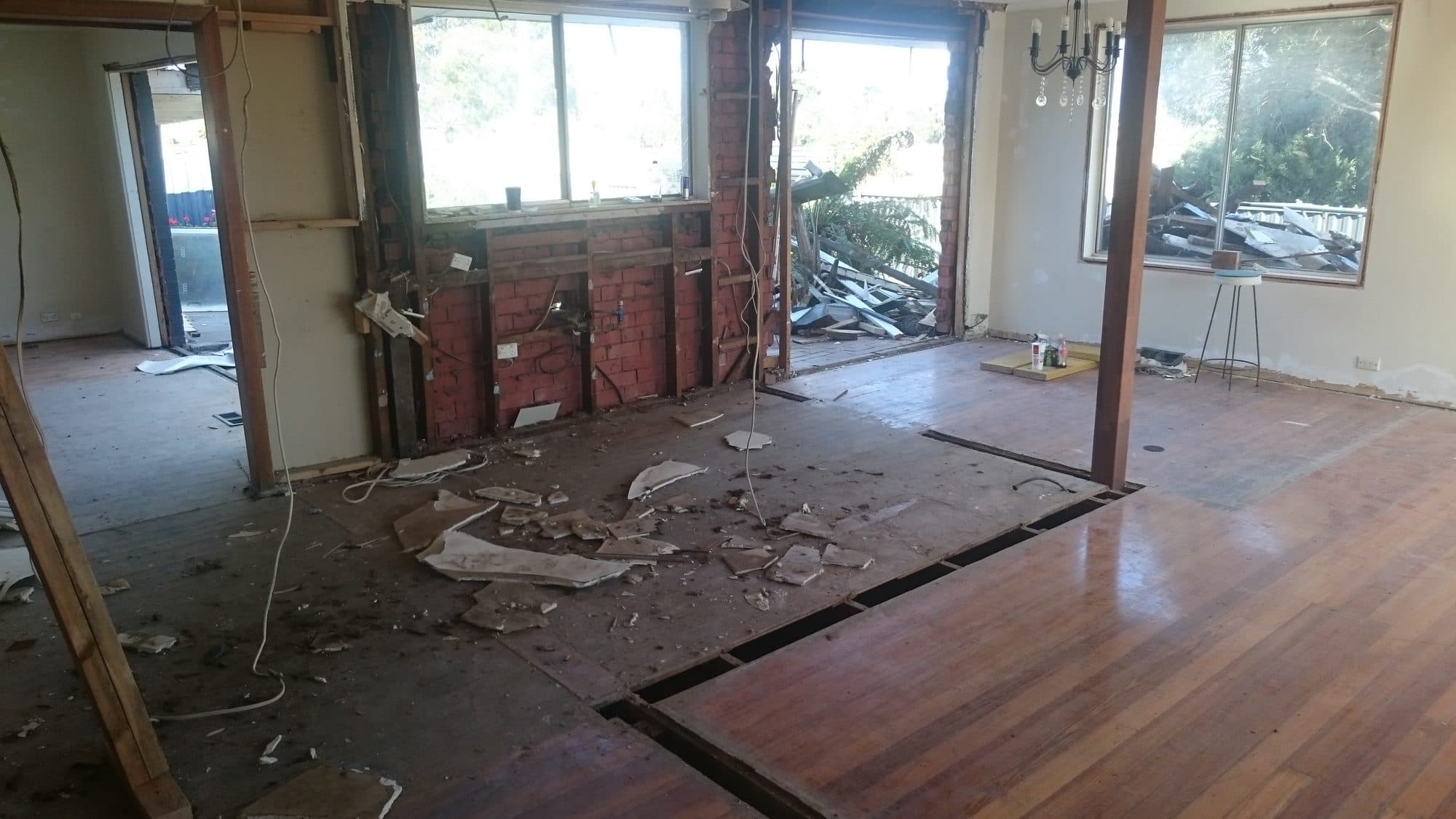 The living area opened up, with the old wall line showing in the floorboards