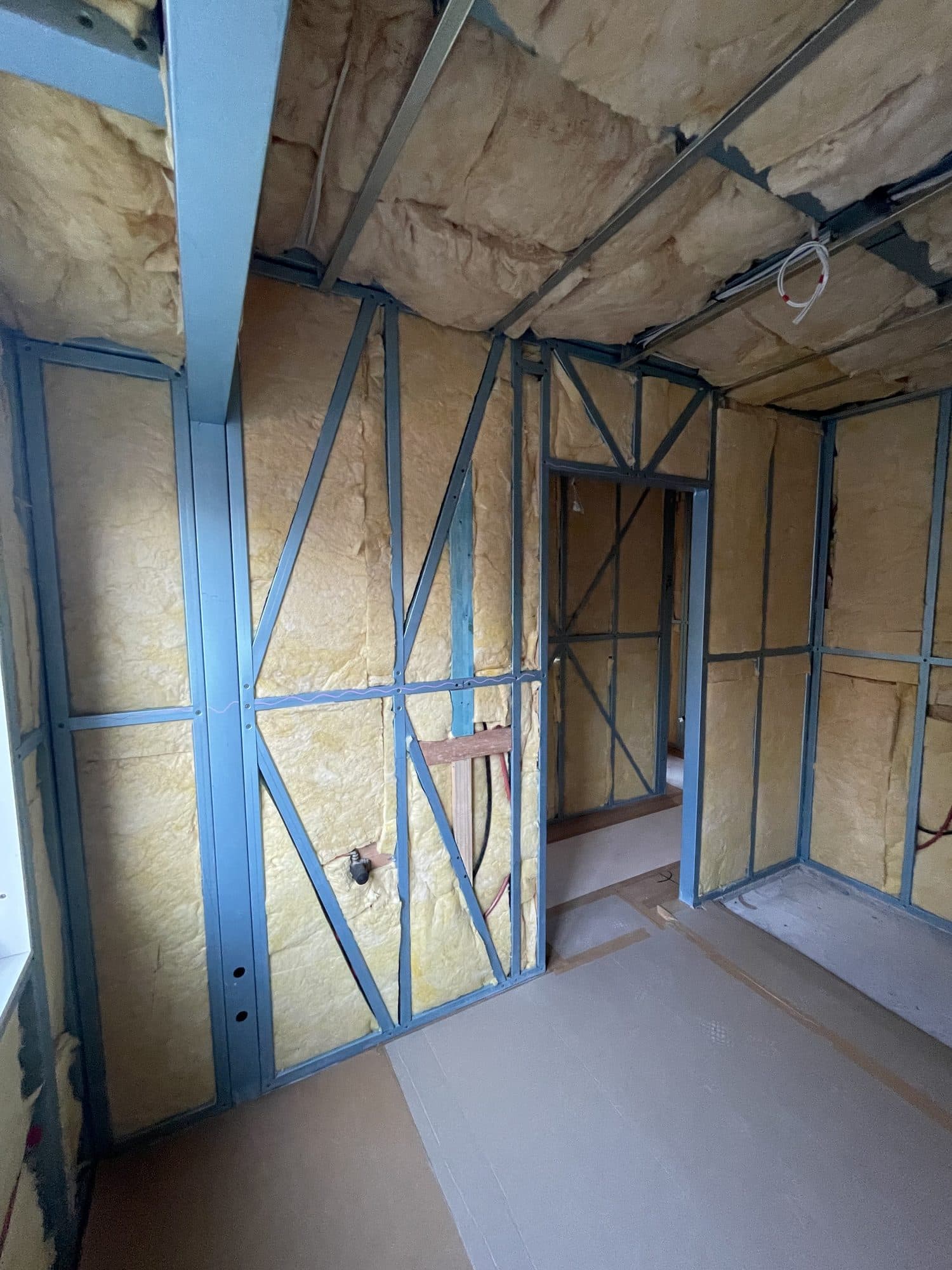 Insulated wall frames around a doorway