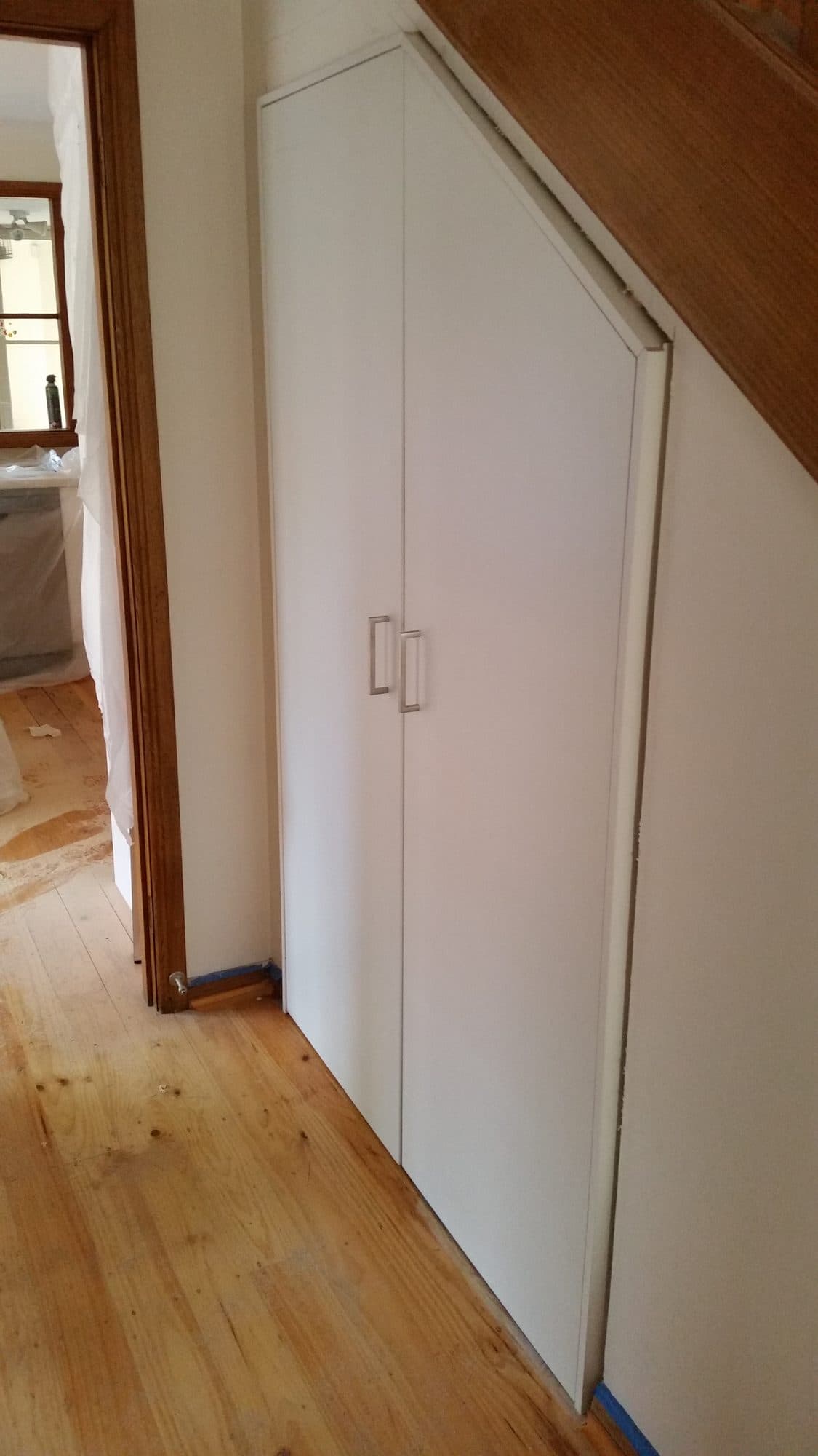 The cupboard doors cut to the angle of the stair
