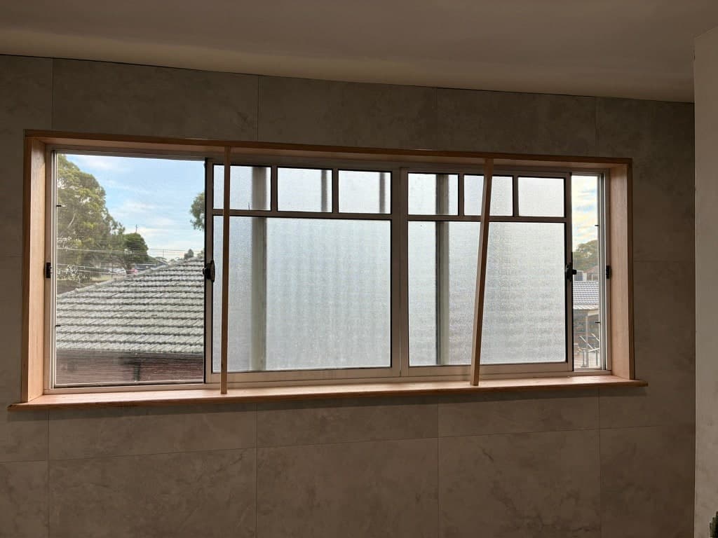 Tiling running up to the window, with the timber reveal in place