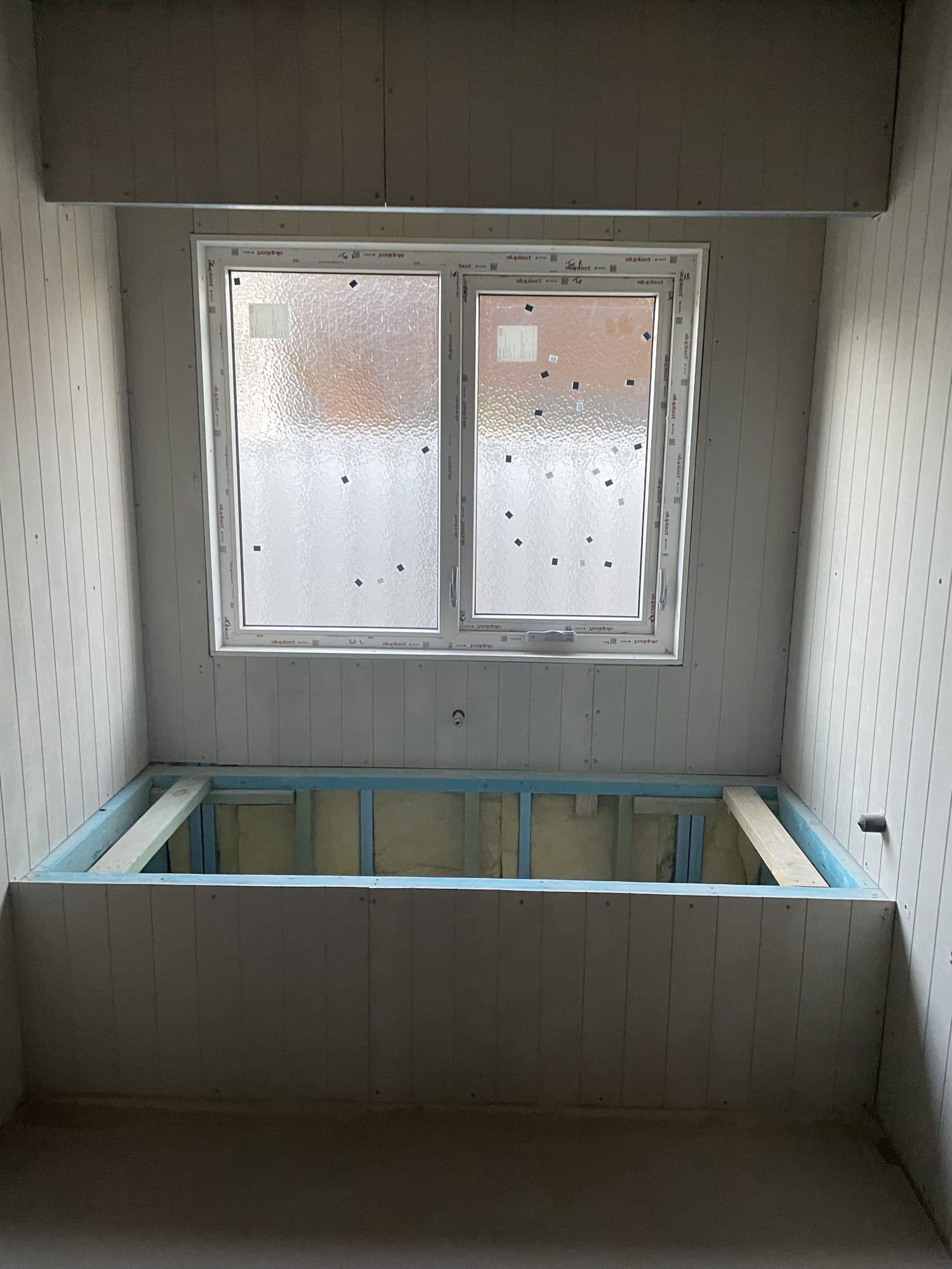 The bath hob framed and lined in the window bay