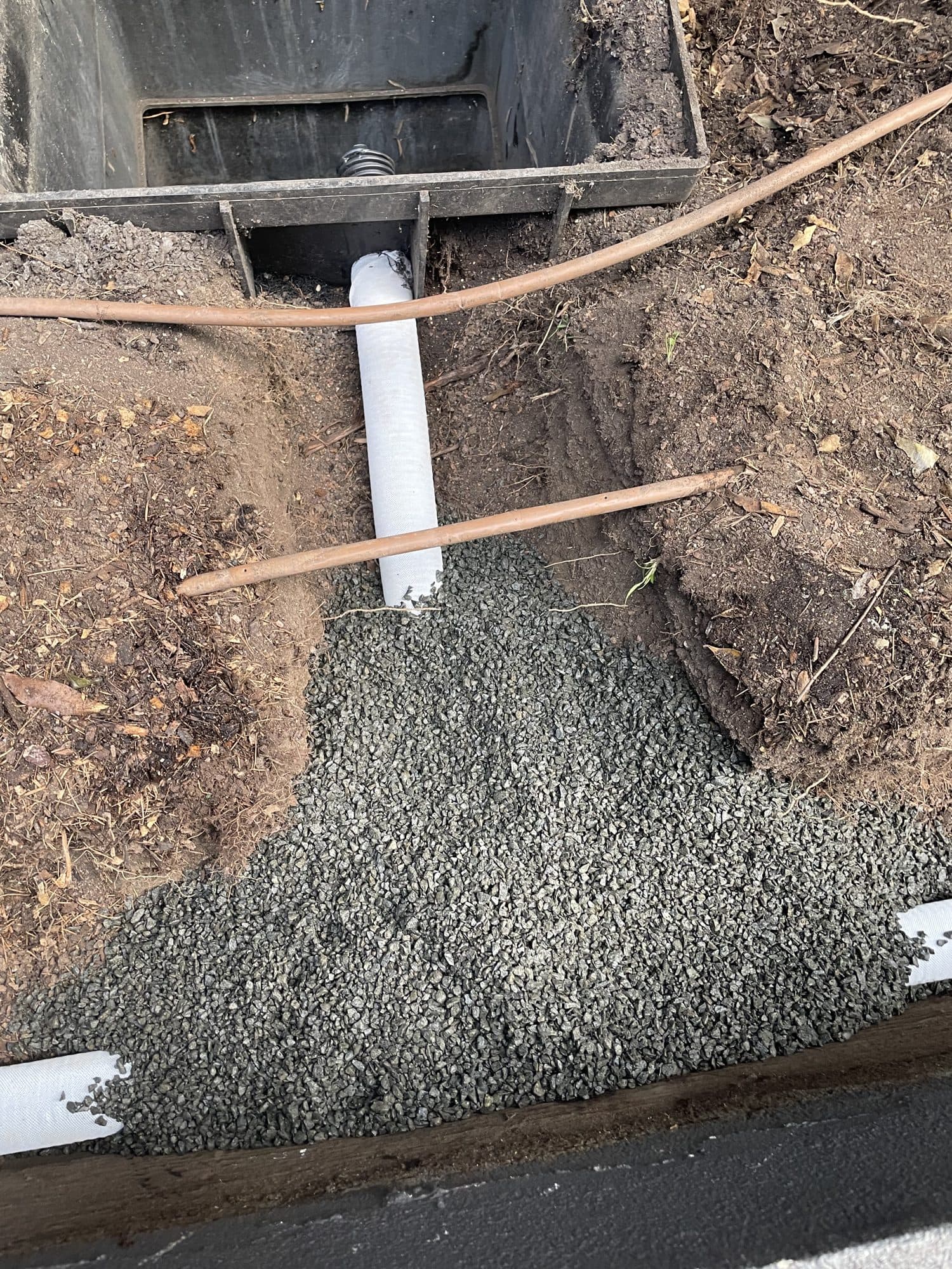 Agricultural drain pipe bedded in gravel