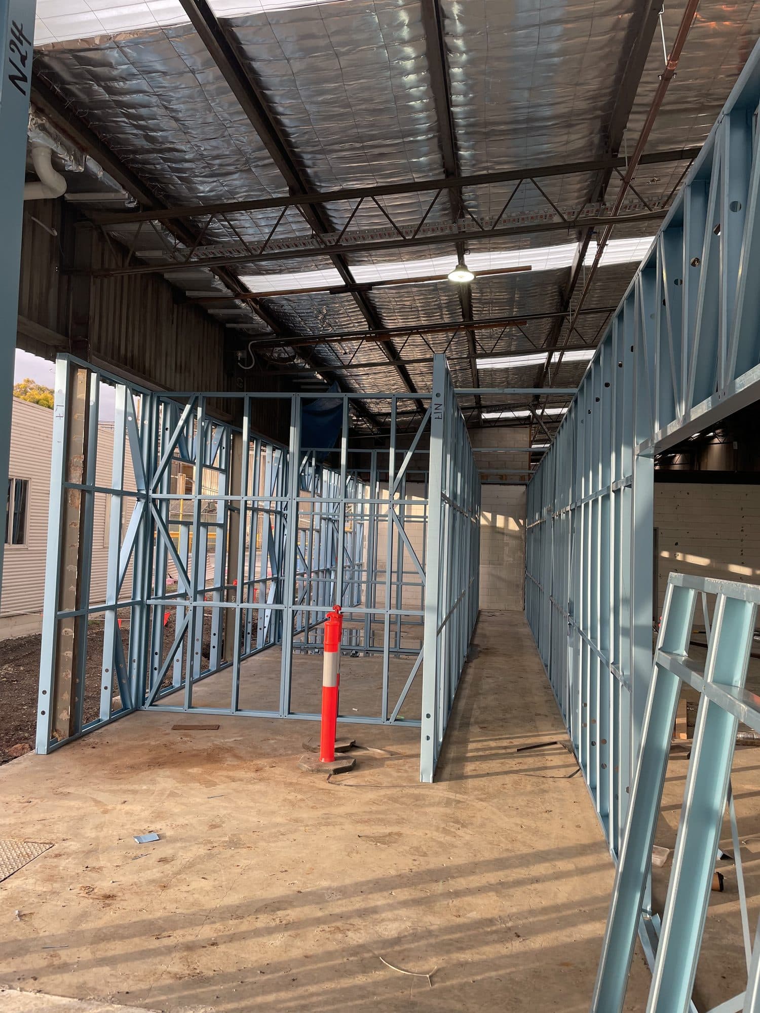 A corridor of steel stud walls
