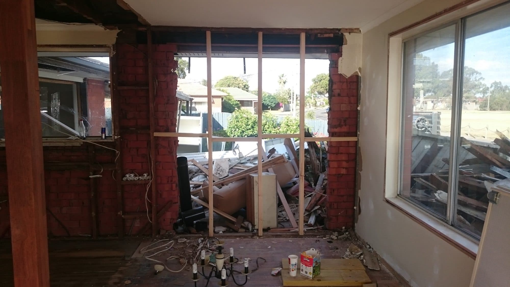 A brick wall opened up and framed with new timber studs