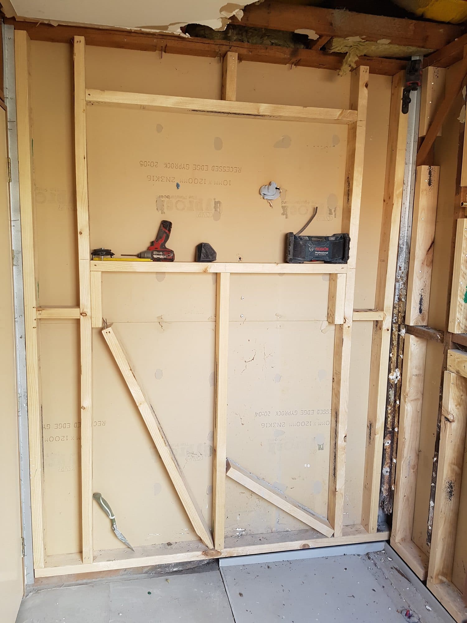 New timber framing on a stripped wall