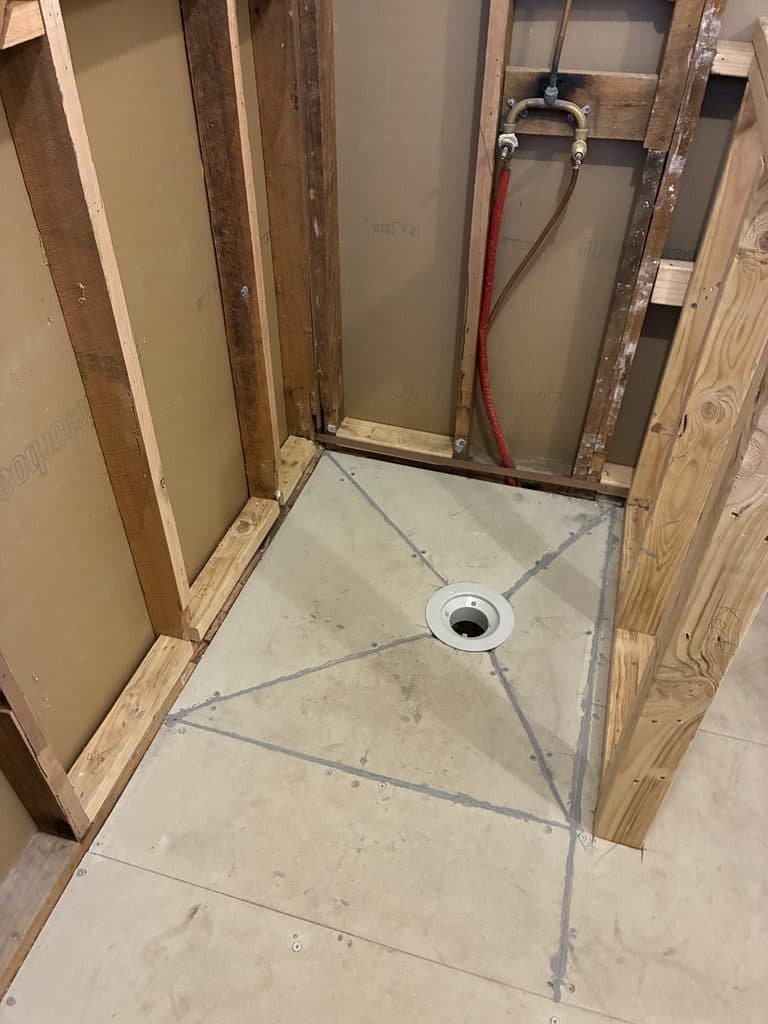The shower floor set out in lines to a centre drain