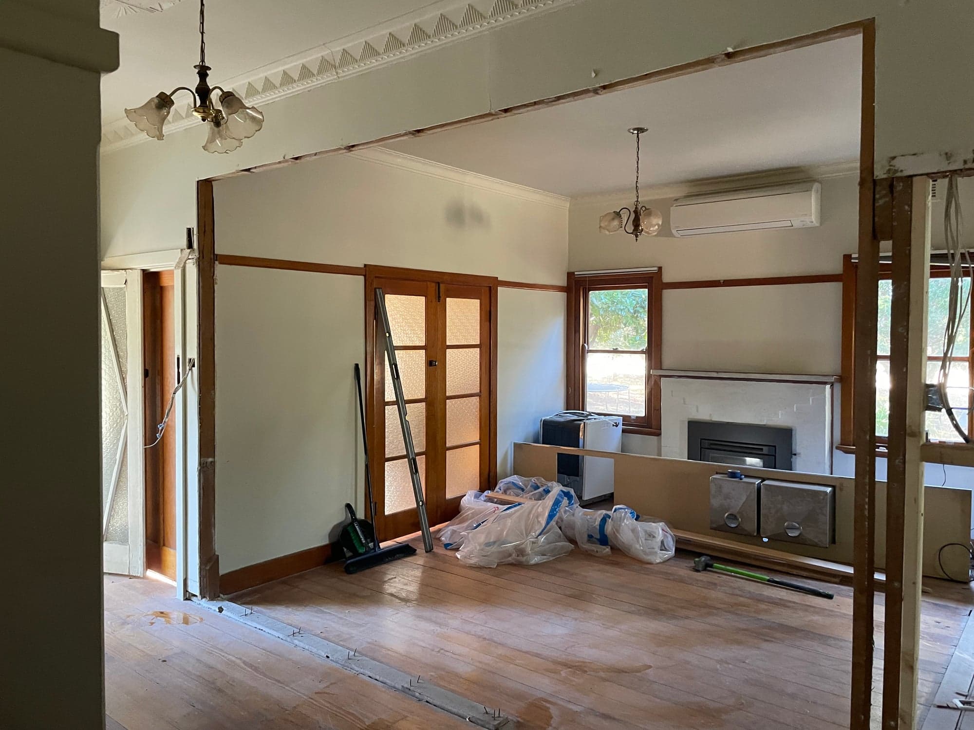 A living room stripped to the studs and ceiling joists