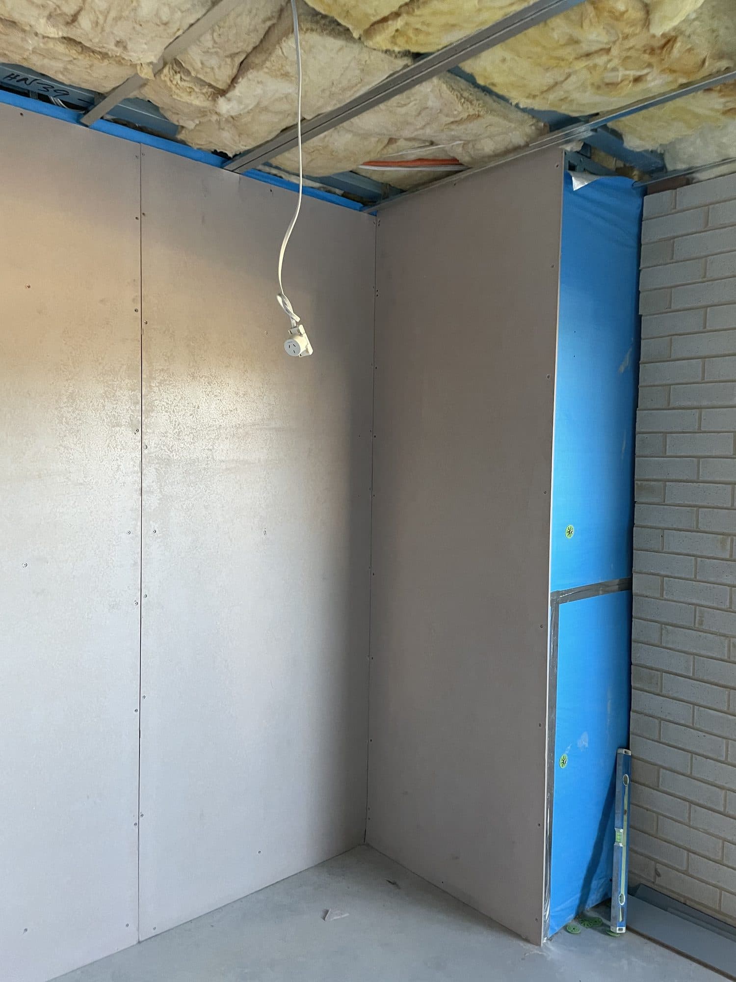 Lined walls in a wet area under the insulated ceiling