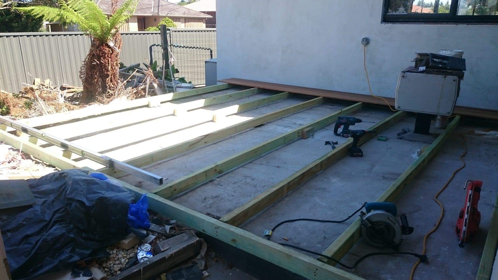 A treated pine deck frame laid over a concrete slab