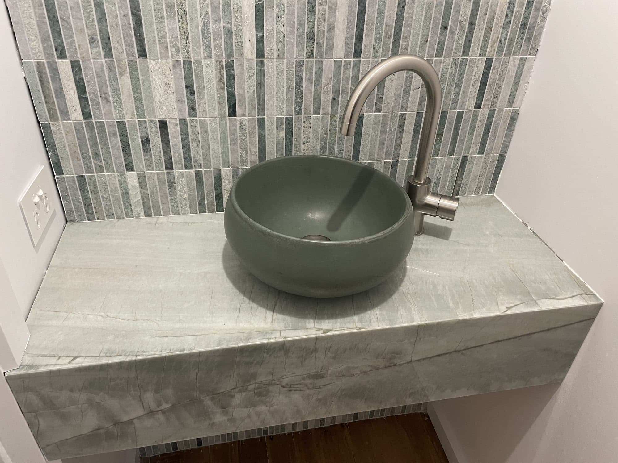 Close view of the stone-clad bench and bowl basin