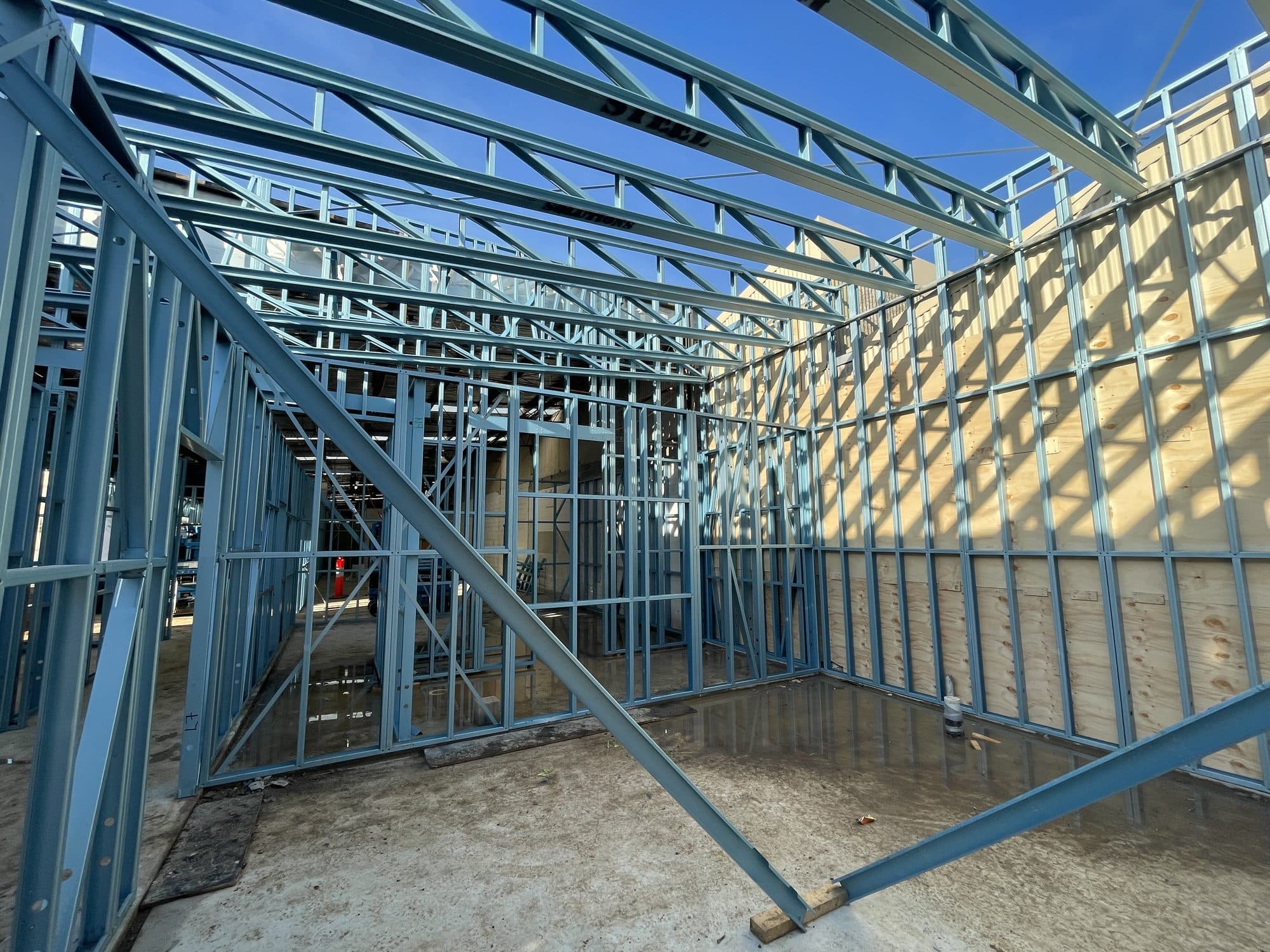A framed room with steel trusses above