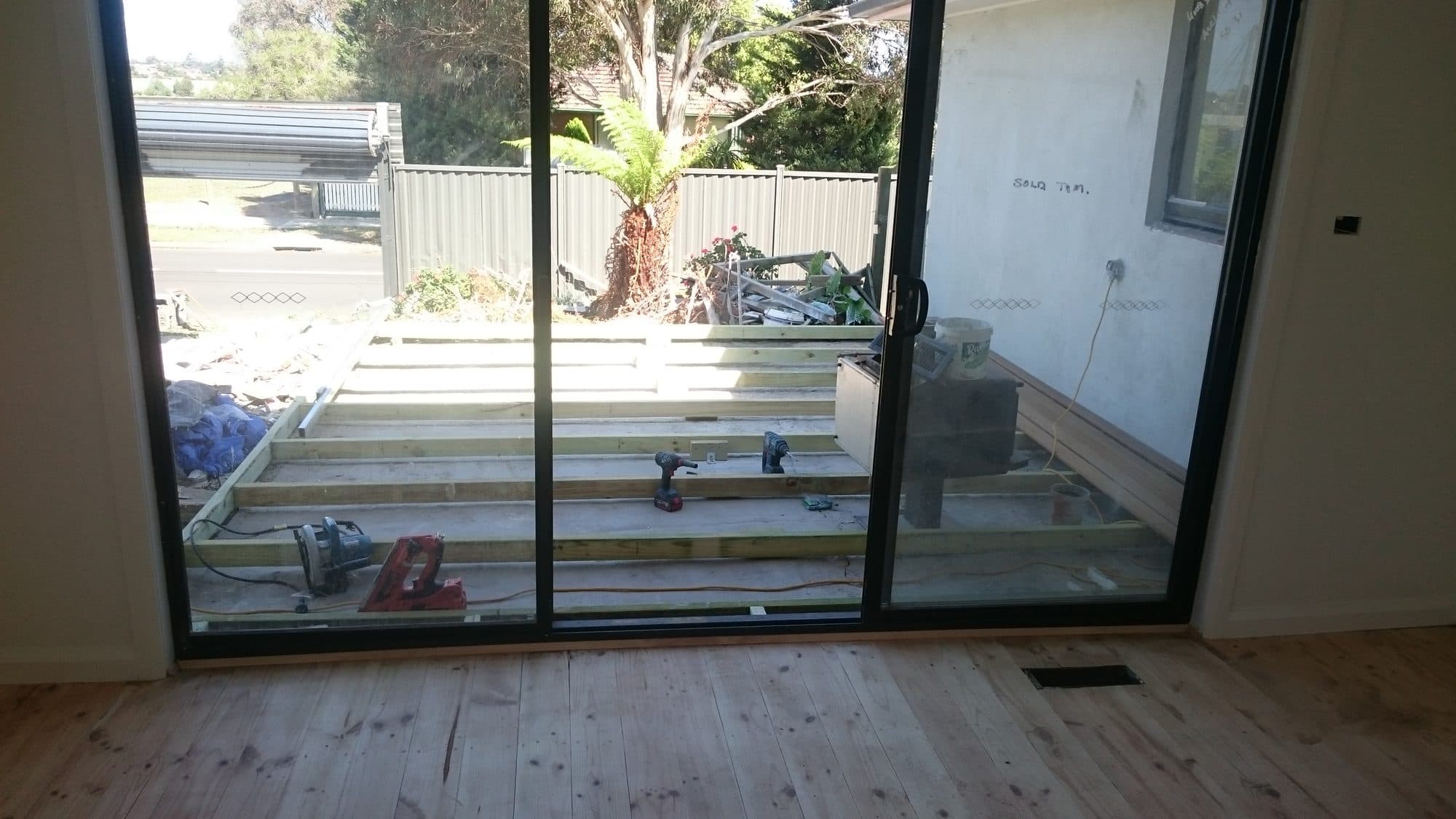 The deck frame seen through new sliding doors from inside