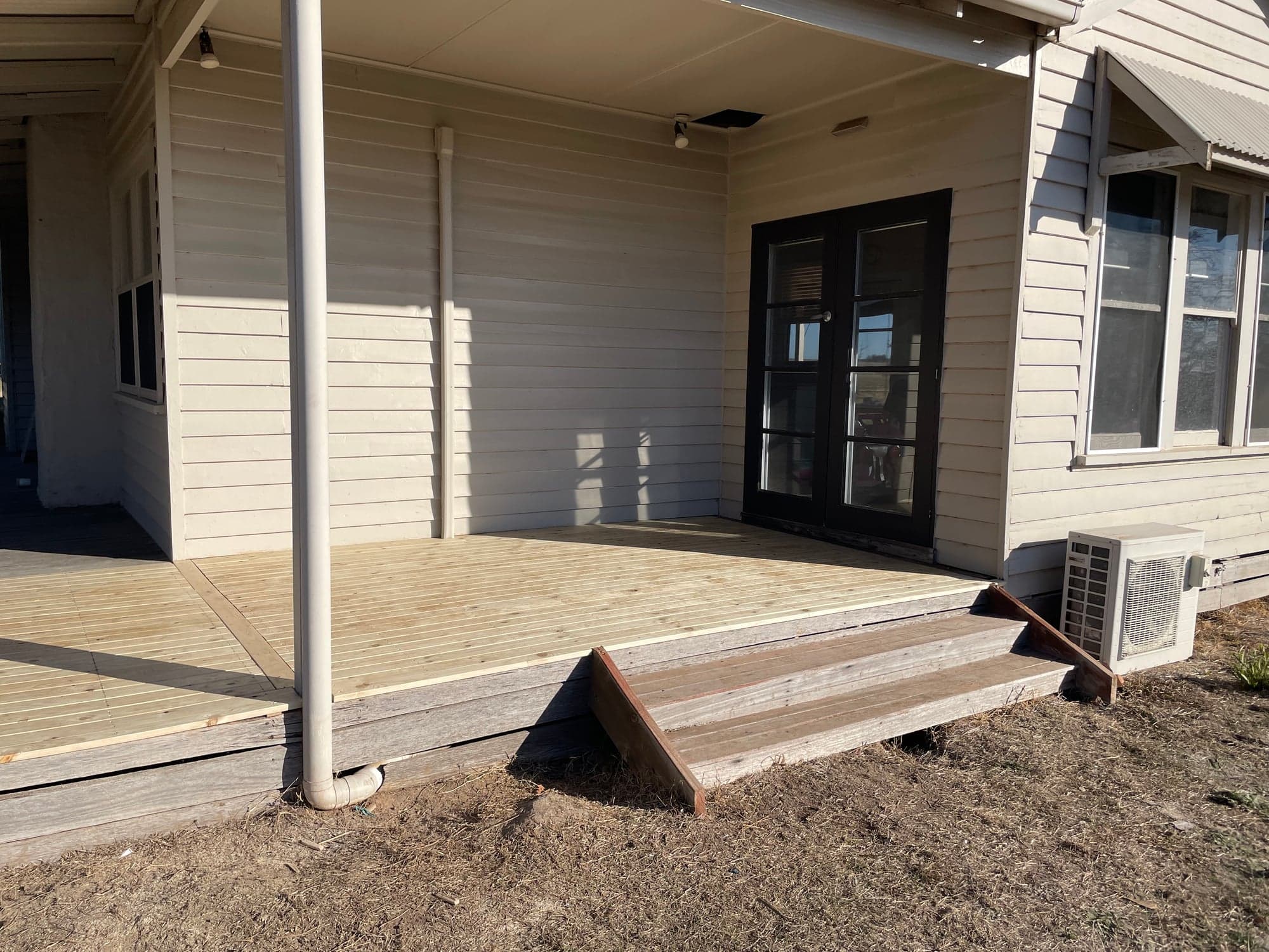 The new deck at the corner of the verandah, with a step down to the yard